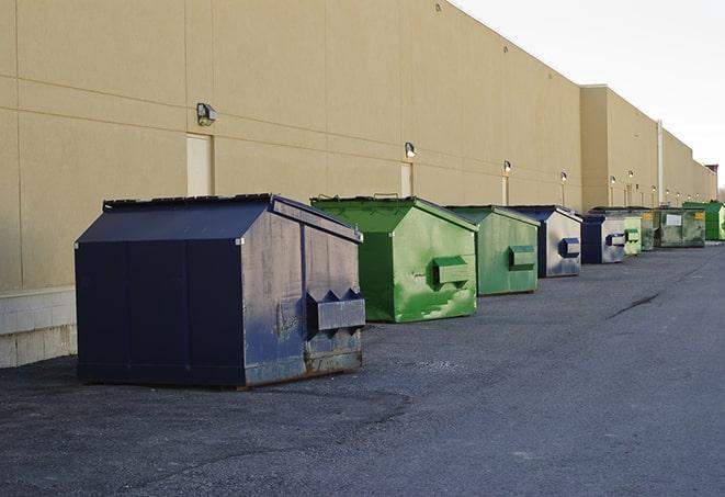 multiple construction dumpsters at a worksite holding various types of debris in Albany NY